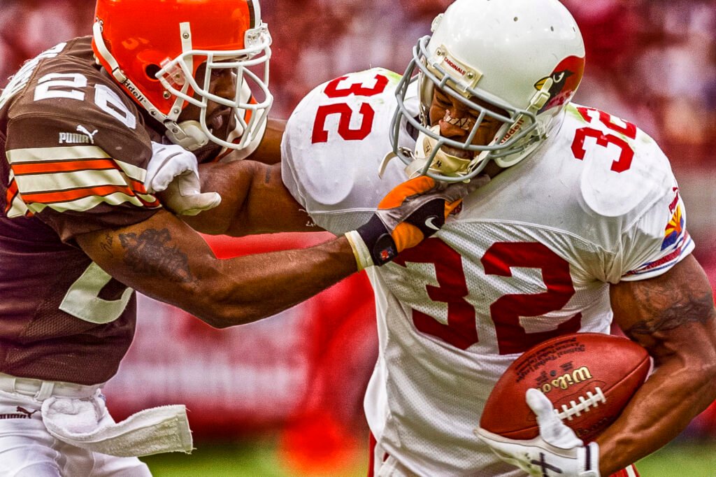Football player in a white number 32 jersey carrying the ball
