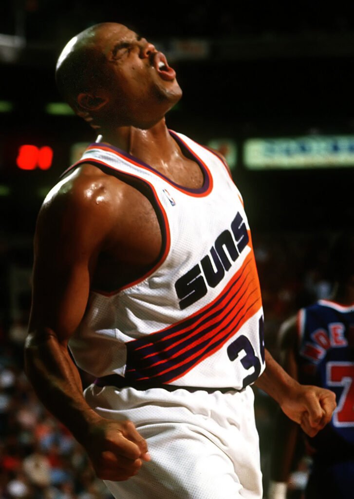 Basketball player in a Suns jersey looking upward