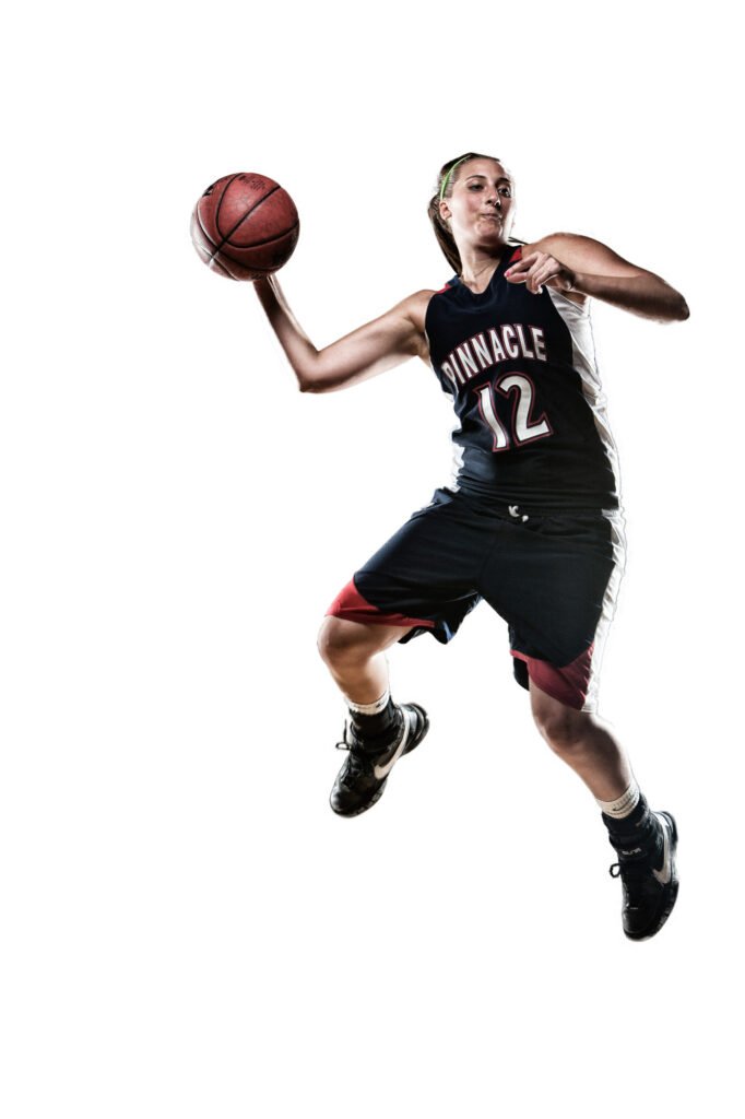 Basketball player jumping with a ball against white
