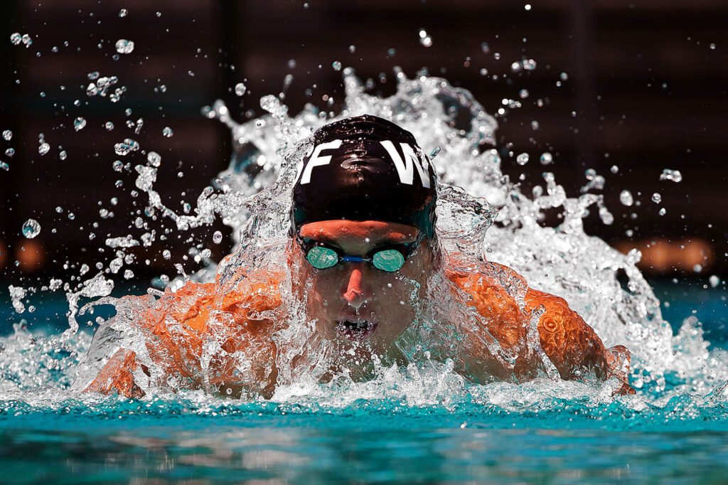 Competitive swimmer moving through splashing water